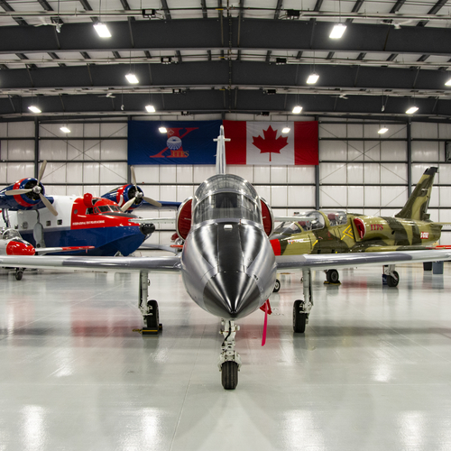 Photo of L-39 aircraft view from front in an airplane hangar.