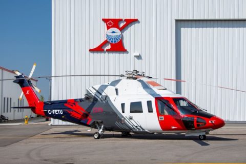 Photo of red and white Sikorsky S-76 helicopter on the tarmac.