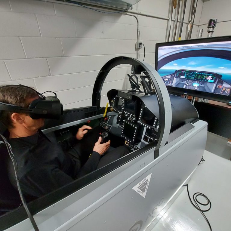 Pilot Billie Flynn flying a simulator with the Varjo mixed reality headset.