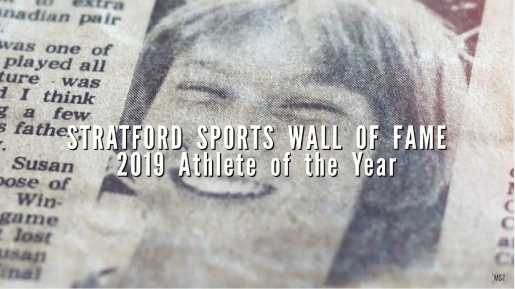 Sue Marsh - Sports Hall of Fame You Tube Video Post Newspaper Clip with a picture of a woman. Overtop there is white text that reads "STRATFORD SPORTS WALL OF FAME 2019 ATHLETE OF THE YEAR"