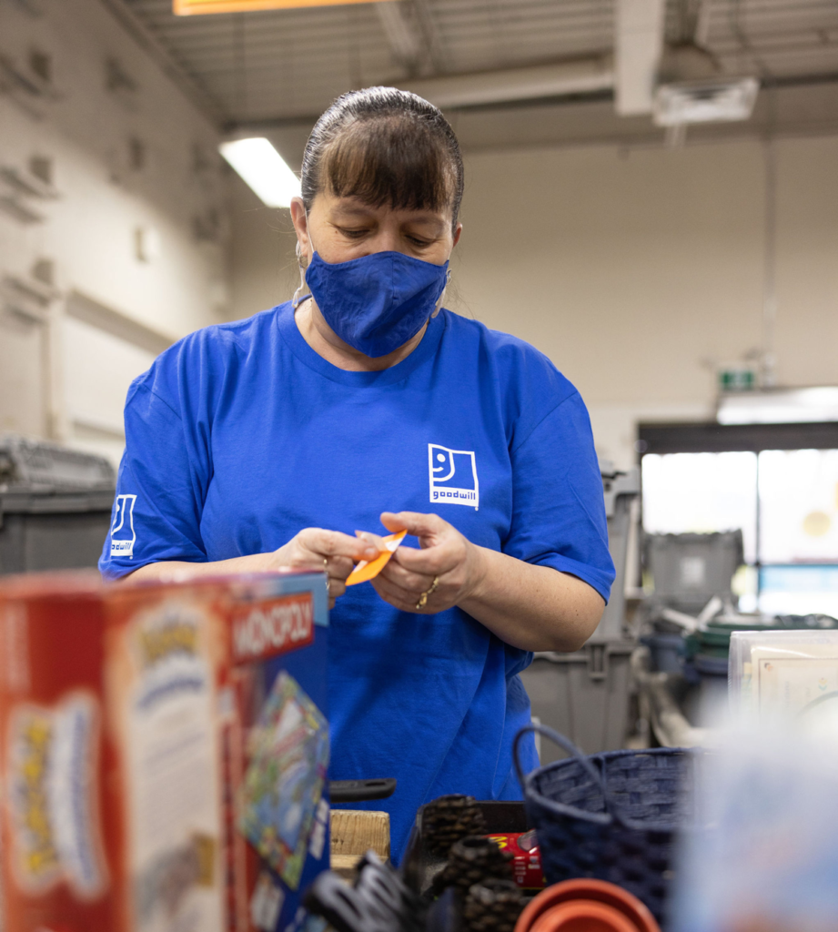 A person at work, tagging donated items for selling