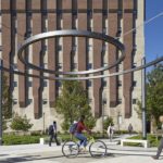 Two circles suspended in the air with students walking beneath