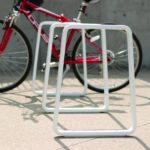 White Iconic bike rack with a red bike behind it