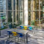 Blue and yellow patio chair at silver patio table