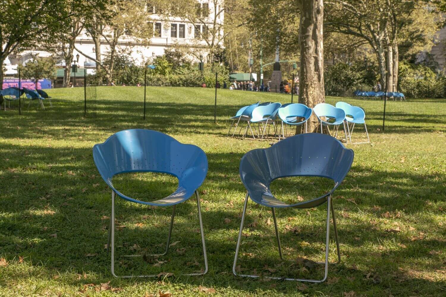 Two blue chairs in a park