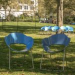Two blue chairs in a park