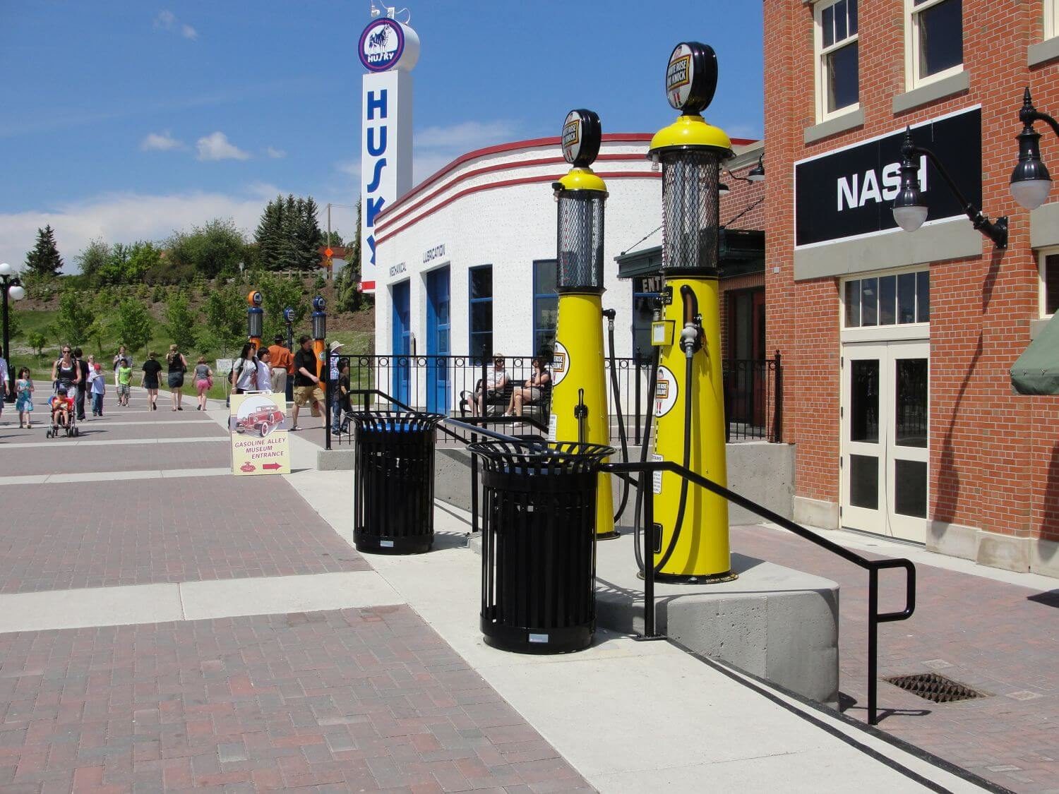 Two black waste bin before stairs leading downwards