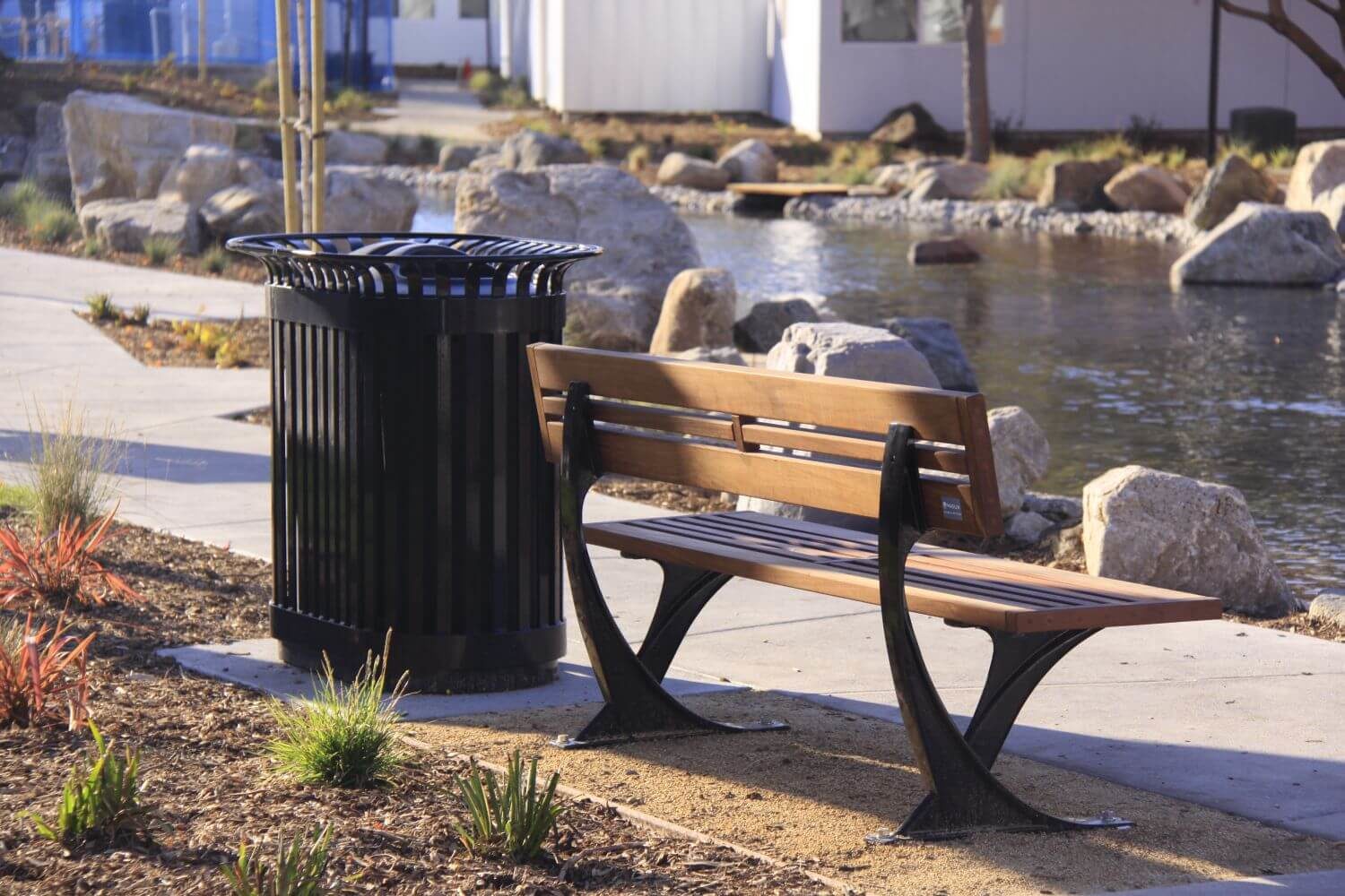 Wooden Bench and Black Bin