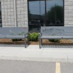 Two metal benches with designs carved in 