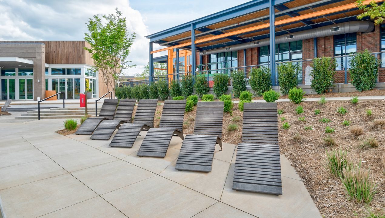 720 wood chaise lounge in a row with building behind