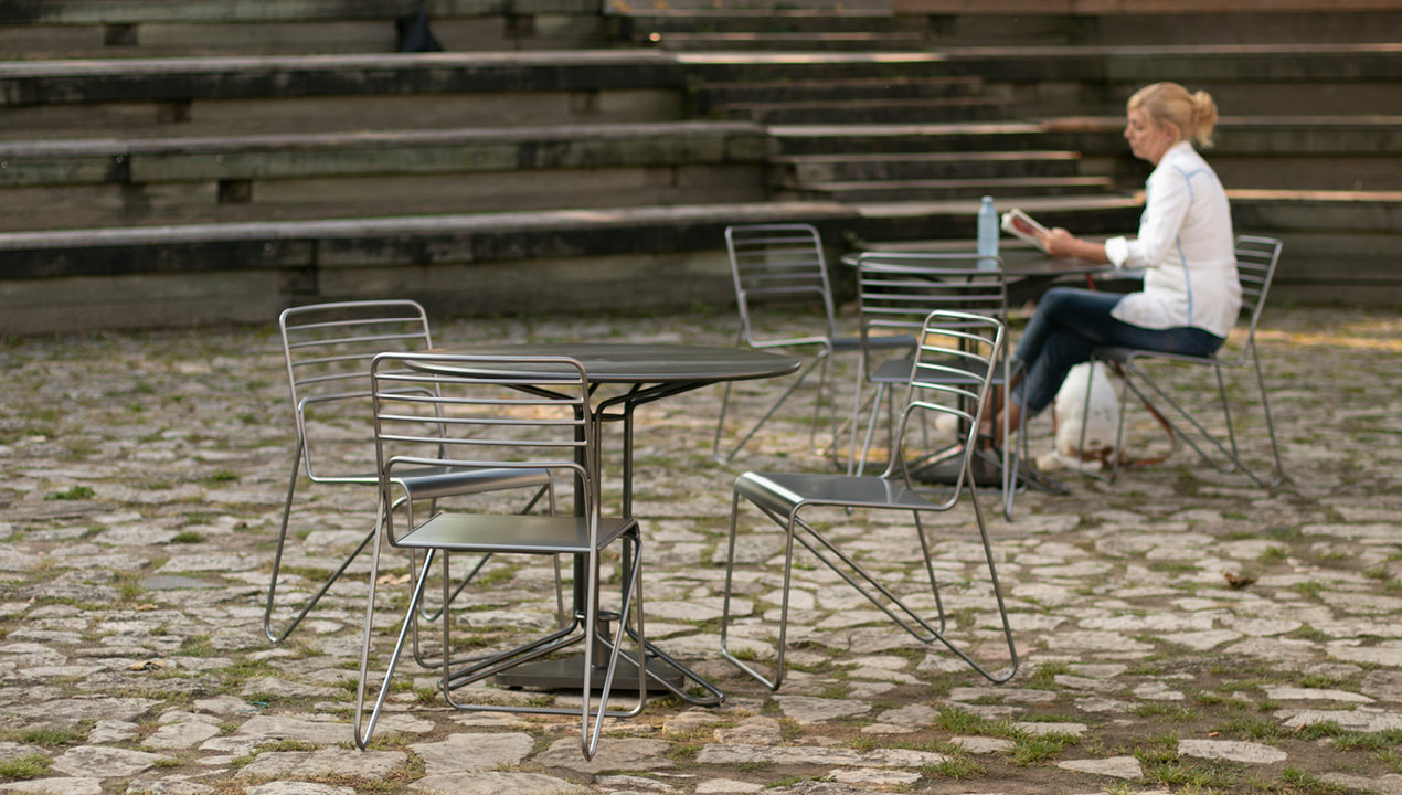 Kontur Cafe Table and Chairs with women wearing white in background