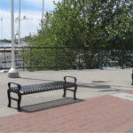 Backless Black Metal Benches with Arms on each end near Water