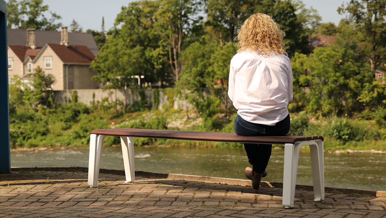 mbe-2300-series_backless-max Woman on bench looking at River