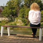 Woman on bench looking at River