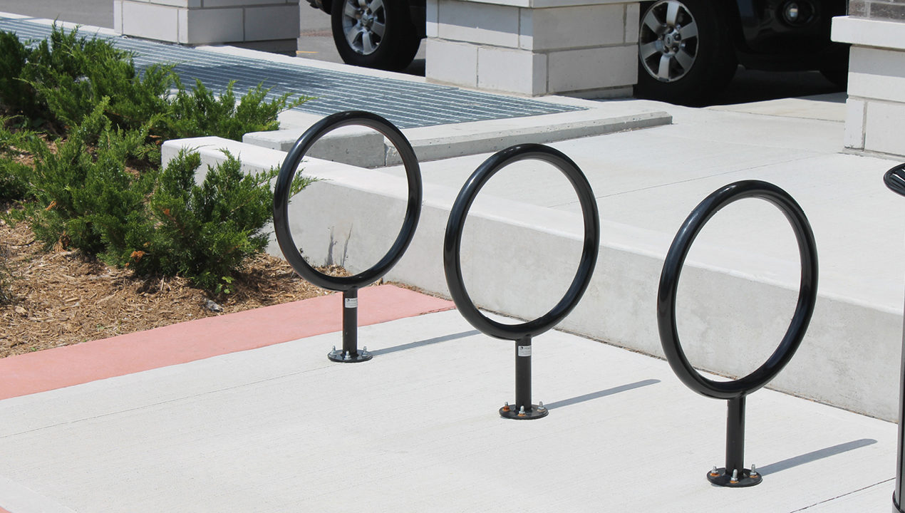 Three black circle bike racks