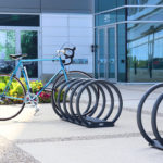 Grey Bike Rack with one bike outside of building