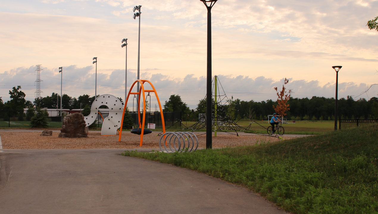 Silver Loop Bike Racks at a children's playground