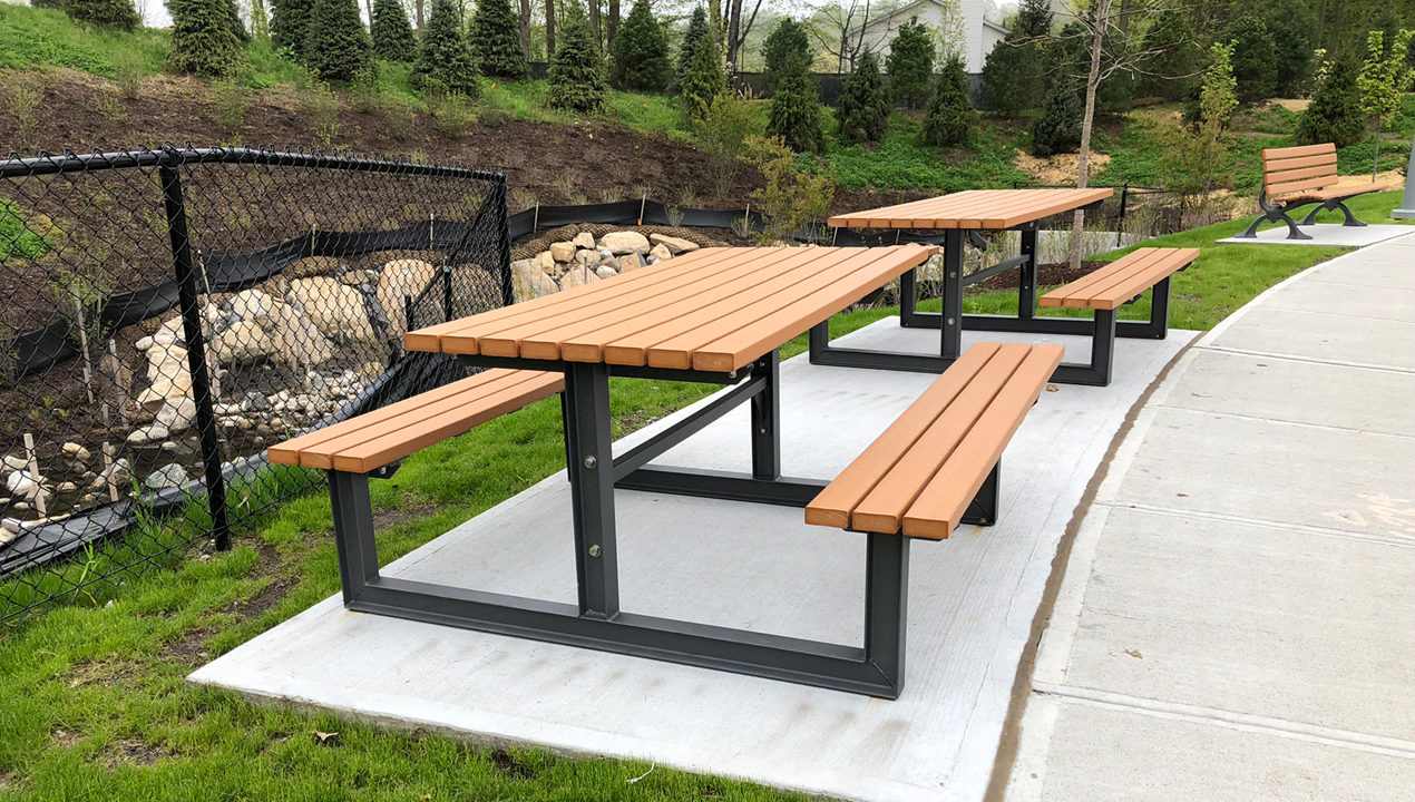 Cedar and Black Metal Picnic Tables near residential area