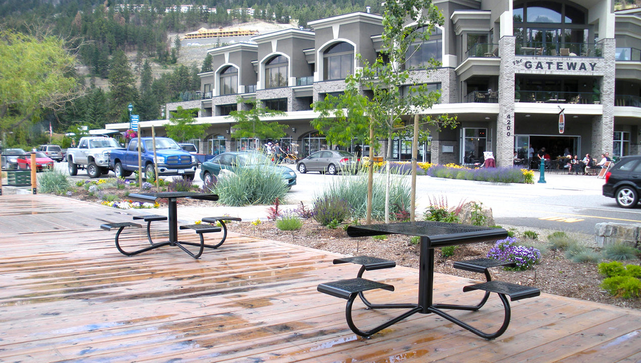 Two Metal Tables on Deck Near Commercial Area