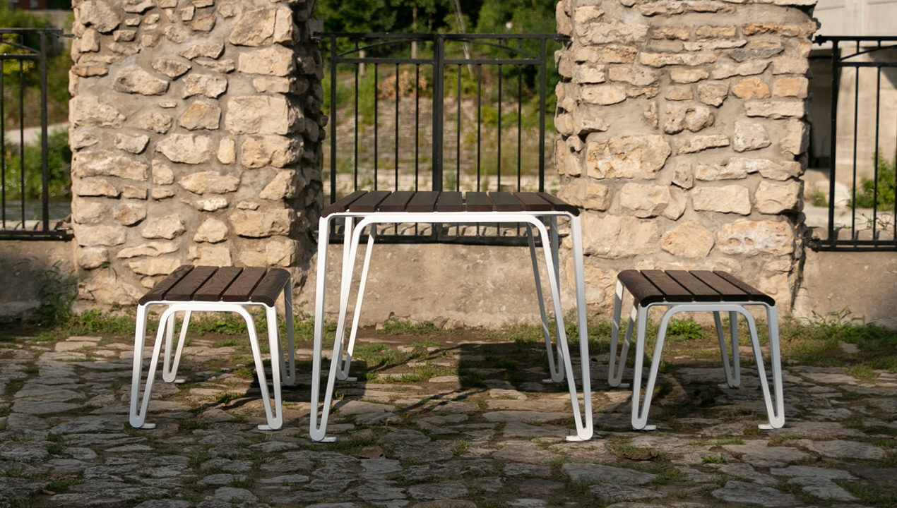 2300 Series Iconic Table and Benches Near Stone Fence