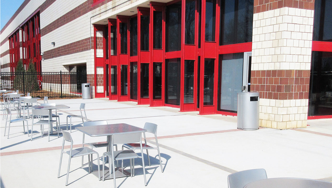 Metal Chairs and Table Outside Red and White Brick Building