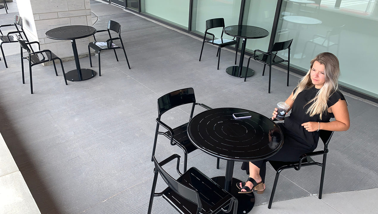 Black Foro tables and chairs with pretty girl having coffee