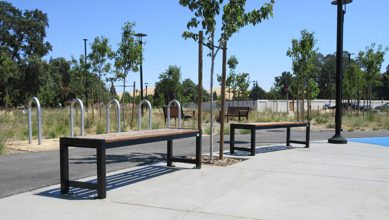 Backless wood 400 benches with trees in background
