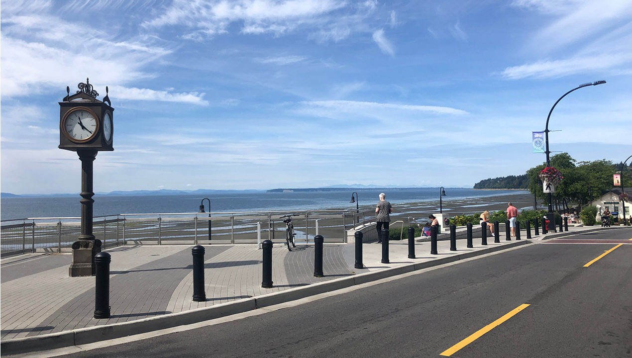600 Series - 650 Bollard Black bollards line street with clock tower and blue skies