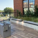 Rooftop patio featuring Ogden straight benches and a fire feature