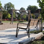 MBE-2300-00017: Iconic Backed Bench with Arms, Ipe Wood Seat and Back in park