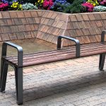 Iconic Backless bench with side and center arms in plaza
