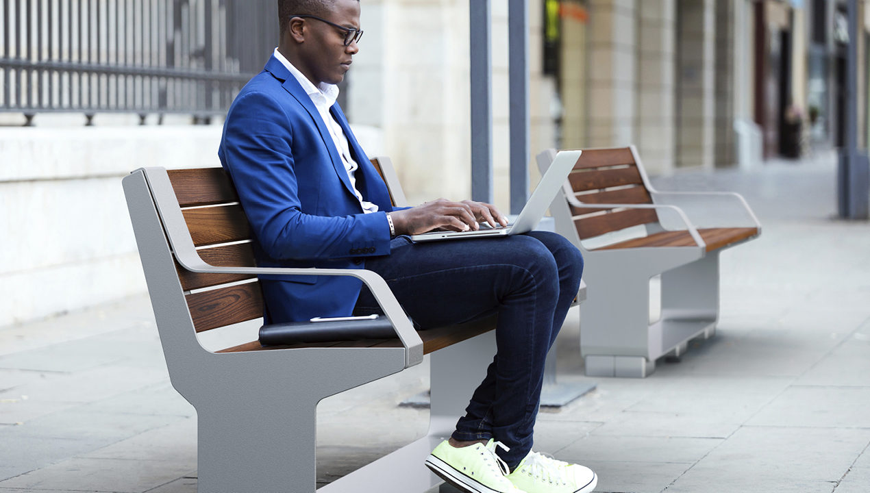 L-Series Backed Benches with handsome man sitting down in city scene