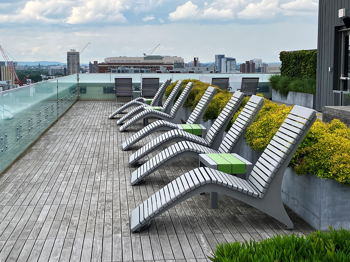 720 Lounges are lined up with 1050 short benches as side tables looking out from the roof deck of Viridian Apartments.