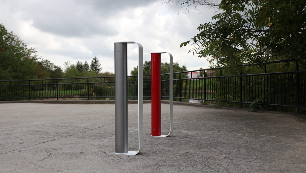 Gunmetal, white and red MUG Bike Racks on a school campus