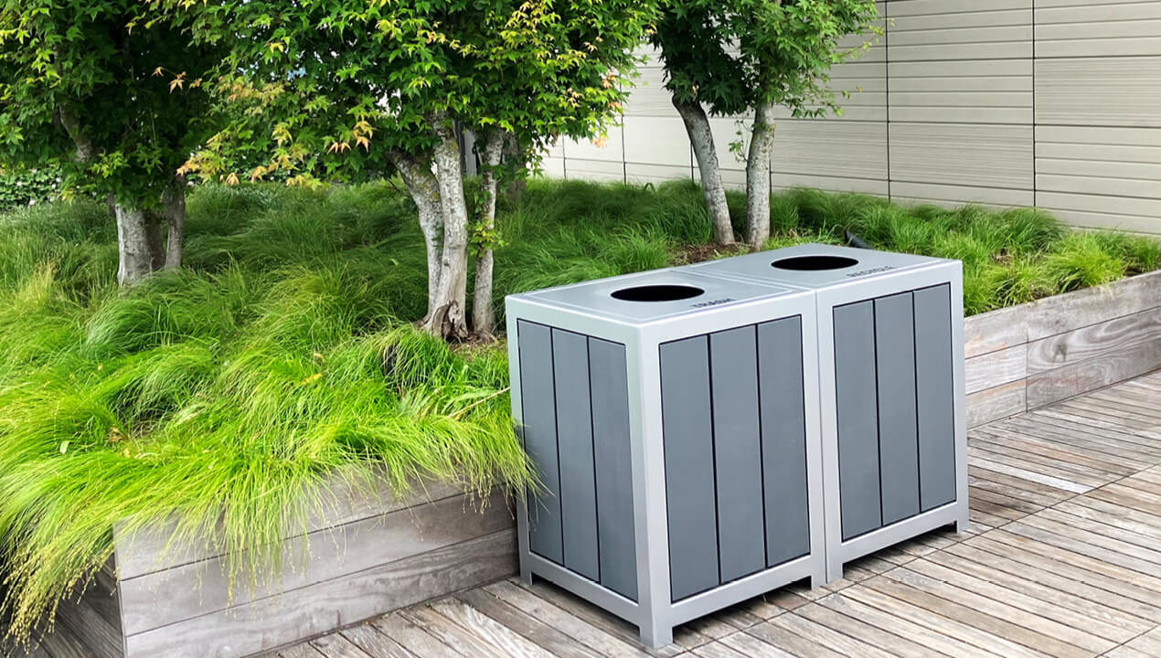 1050 Waste and Recycle Containers with bright green grasses in the background