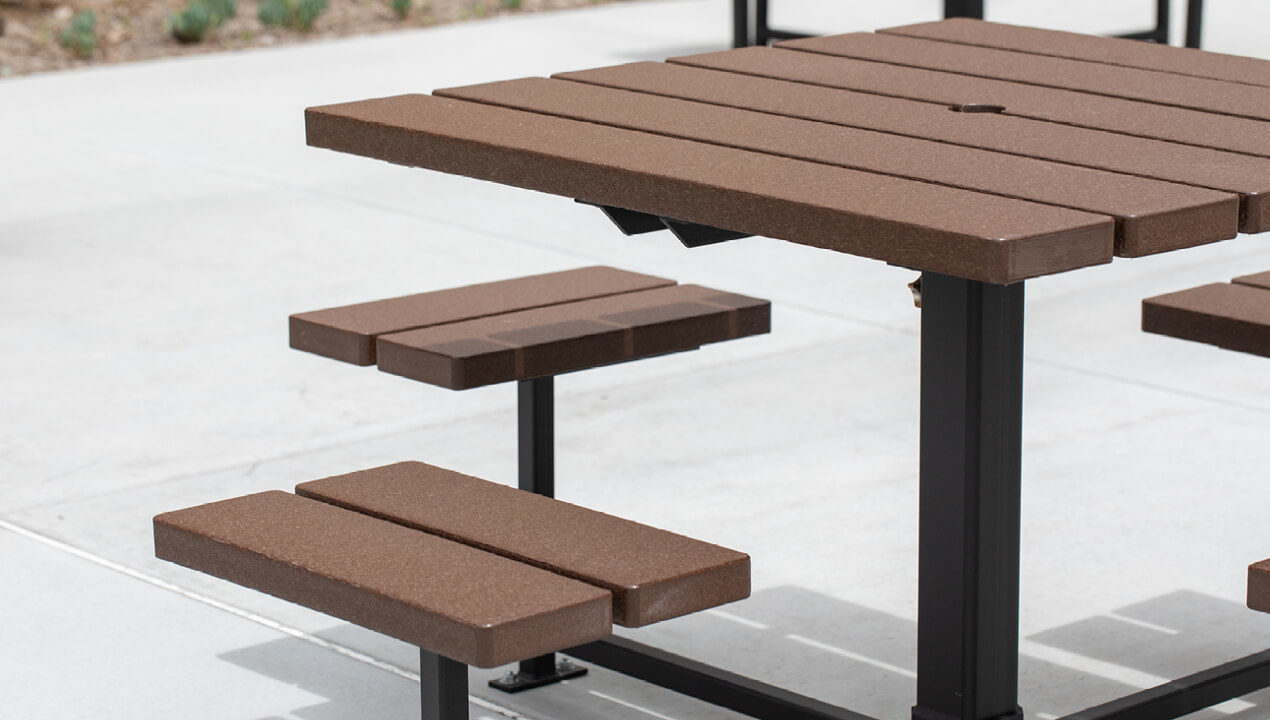 Close-up of 400 Cluster Seating with wood grain texture high density polyethylene and umbrella hole