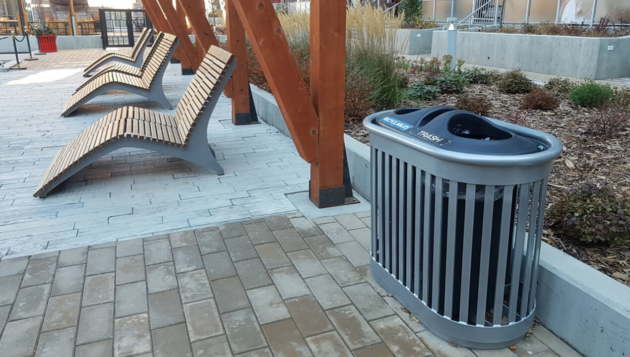 200 Series - 250 Recycle Receptacle and 720 Chaise Lounges occupy an outdoor patio