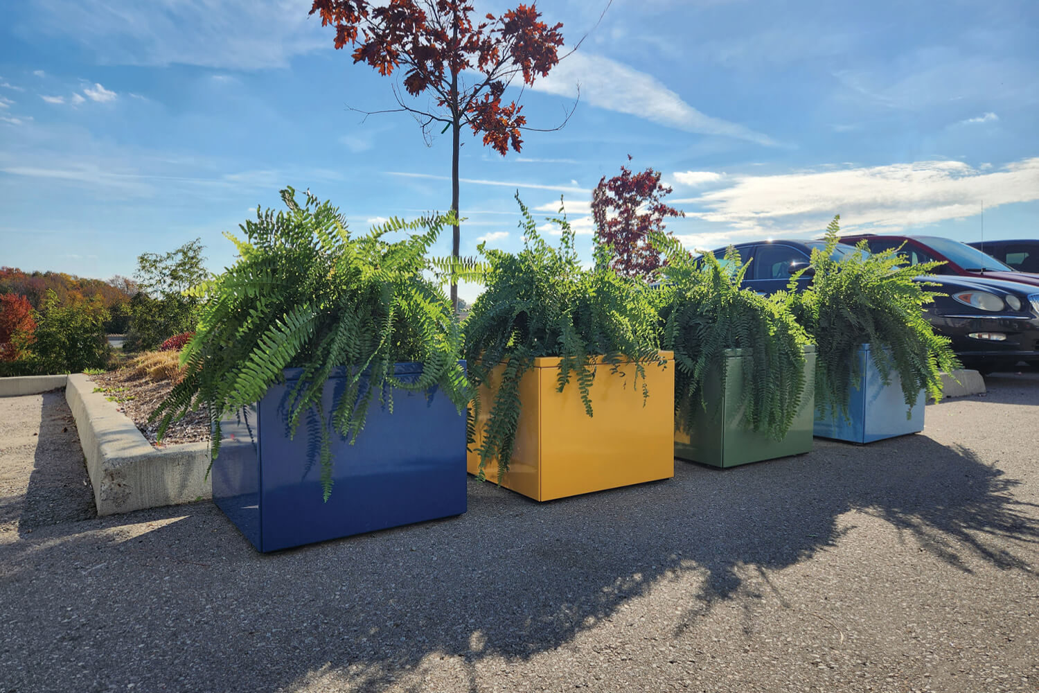 Pixel planters painted in mellow powdercoat colors with blue skies