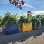 Pixel planters painted in mellow powdercoat colors with blue skies