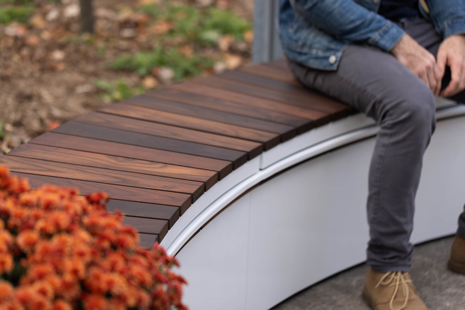 Curved Ogden Bench on CANOE modular planter with man sitting
