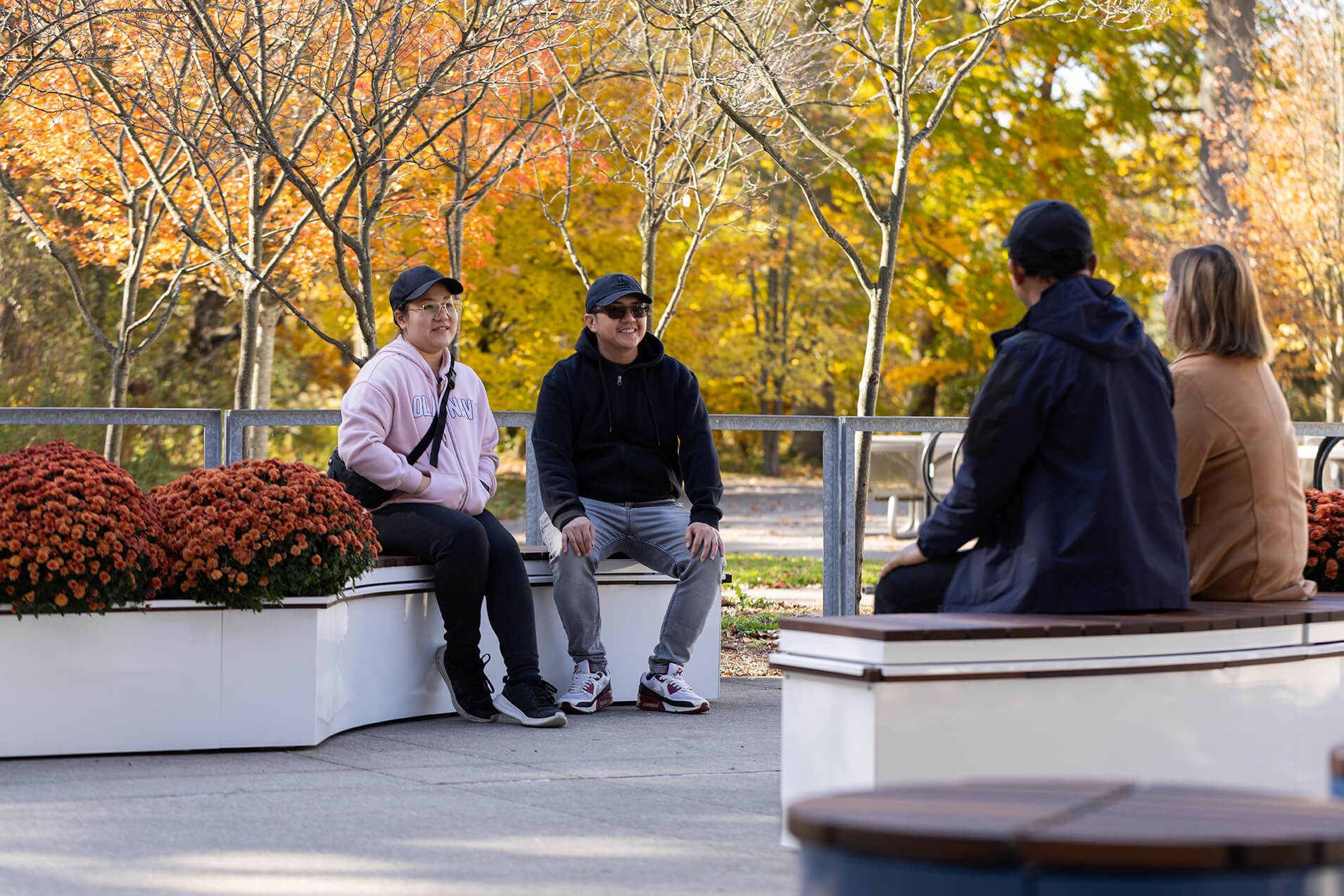 Fall day with people sitting on CANOE modular planters
