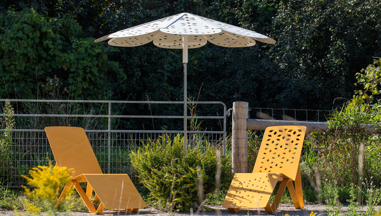 ROMA Sun Shade with ALUM Chaise Lounge chairs in scenic location surrounded by trees and greenery