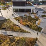 Over head view of the green space at AGORA Plaza in autumn. The image shows the pathways lined by comfortable Ogden benches.