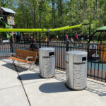 A backed Maglin bench sits with some waste and recycle containers in front of Rosedale Nature Park