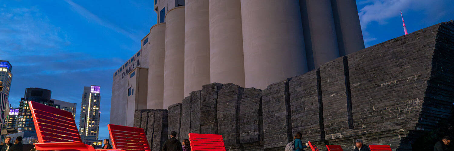 Maglin 720 Chairs brightly lit up against beautiful dark blue sky and silos at Bathurst Quay Commons