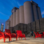 Maglin 720 Chairs brightly lit up against beautiful dark blue sky and silos at Bathurst Quay Commons