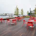 Several Maglin Foro tables and chairs overlooking the water at Bathurst Quay Common in Toronto Ontario
