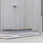 Maglin Pixel Blocks painted in light to dark gradient with short blocks stacked outside a building at CSUSM