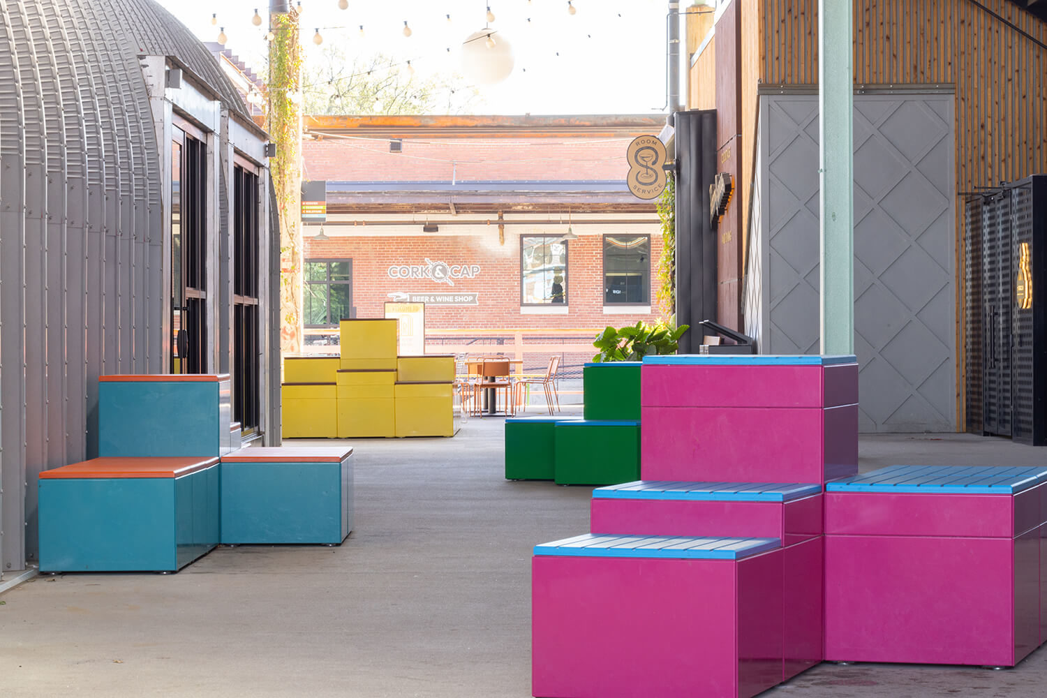 Brightyl painted Pixex block configurations line a walkway at Camp North End