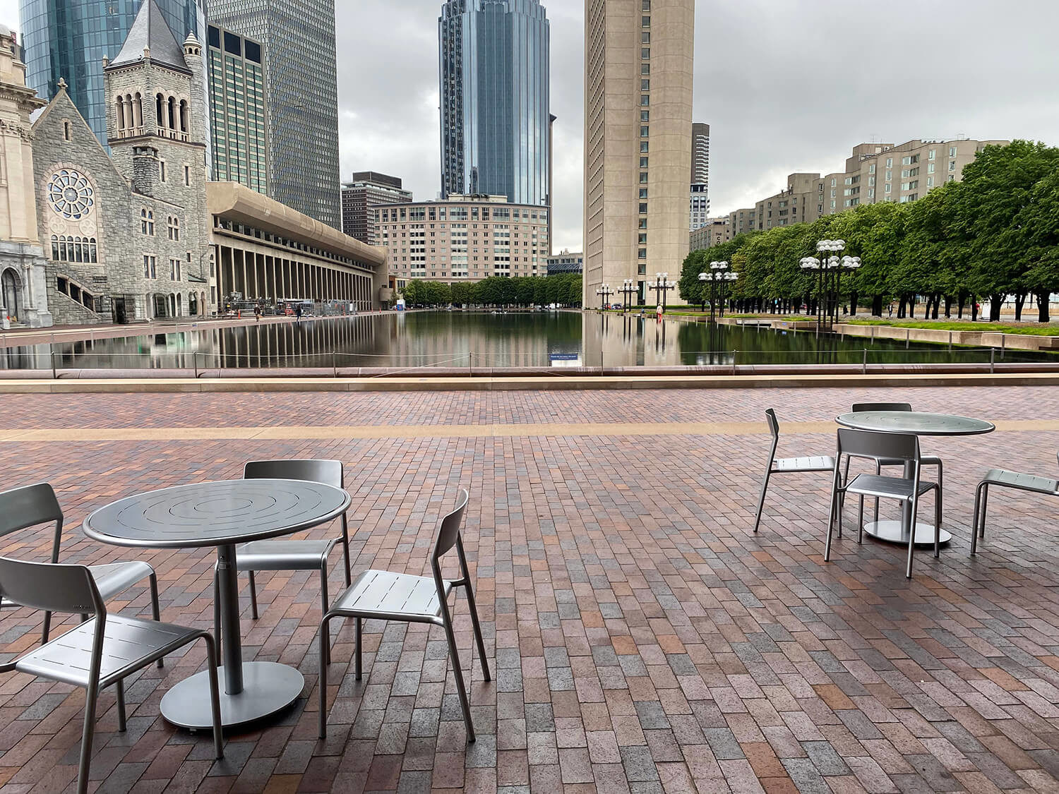 Maglin Foro tables and seating in front of water feature at Christian Science Plaza